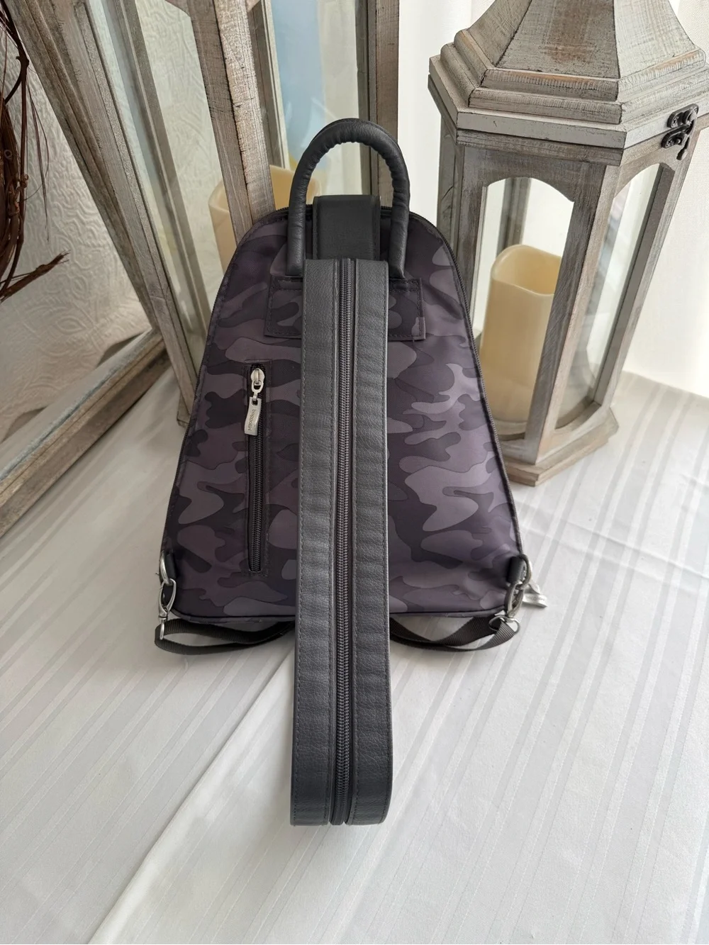 Baggallini MM Metro Backpack in a Dark Gray Camo print.